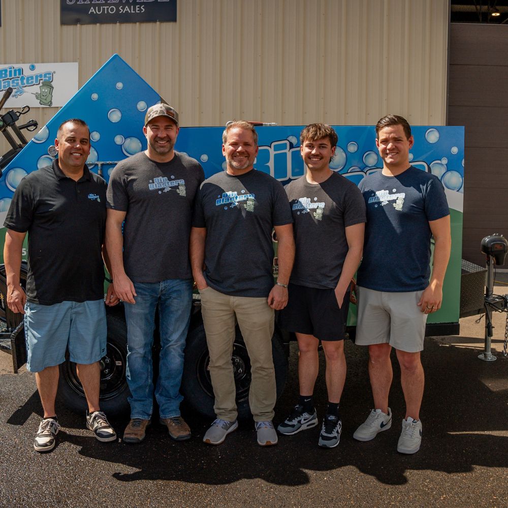 The Bin Blasters team in front of a Bin Blasters trailer